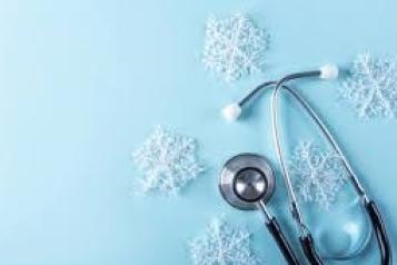 There is a light blue background. In the right hand corner there is a stethoscope. Around the stethoscope is five snowflakes. 