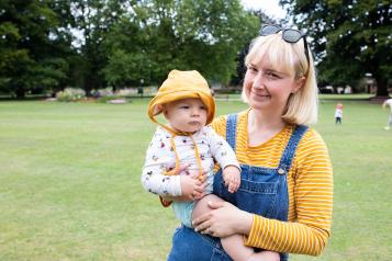 Woman holding her child at a picnic