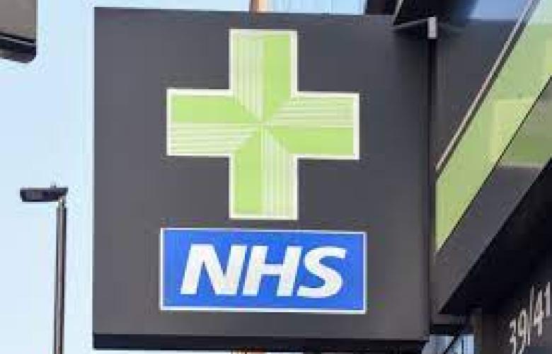 NHS white and blue logo underneath a green pharmacy cross 